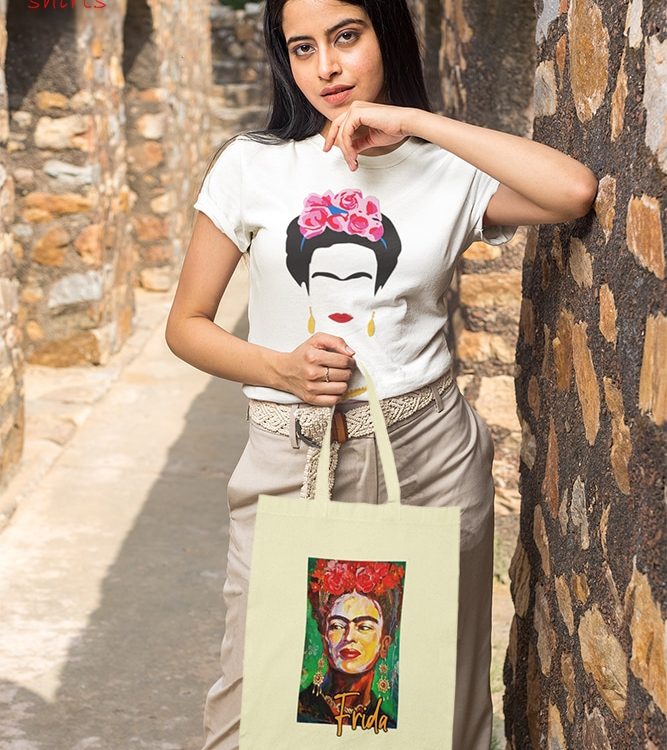 t-shirt-mockup-of-a-woman-holding-a-tote-bag-by-a-stone-arch-m25843